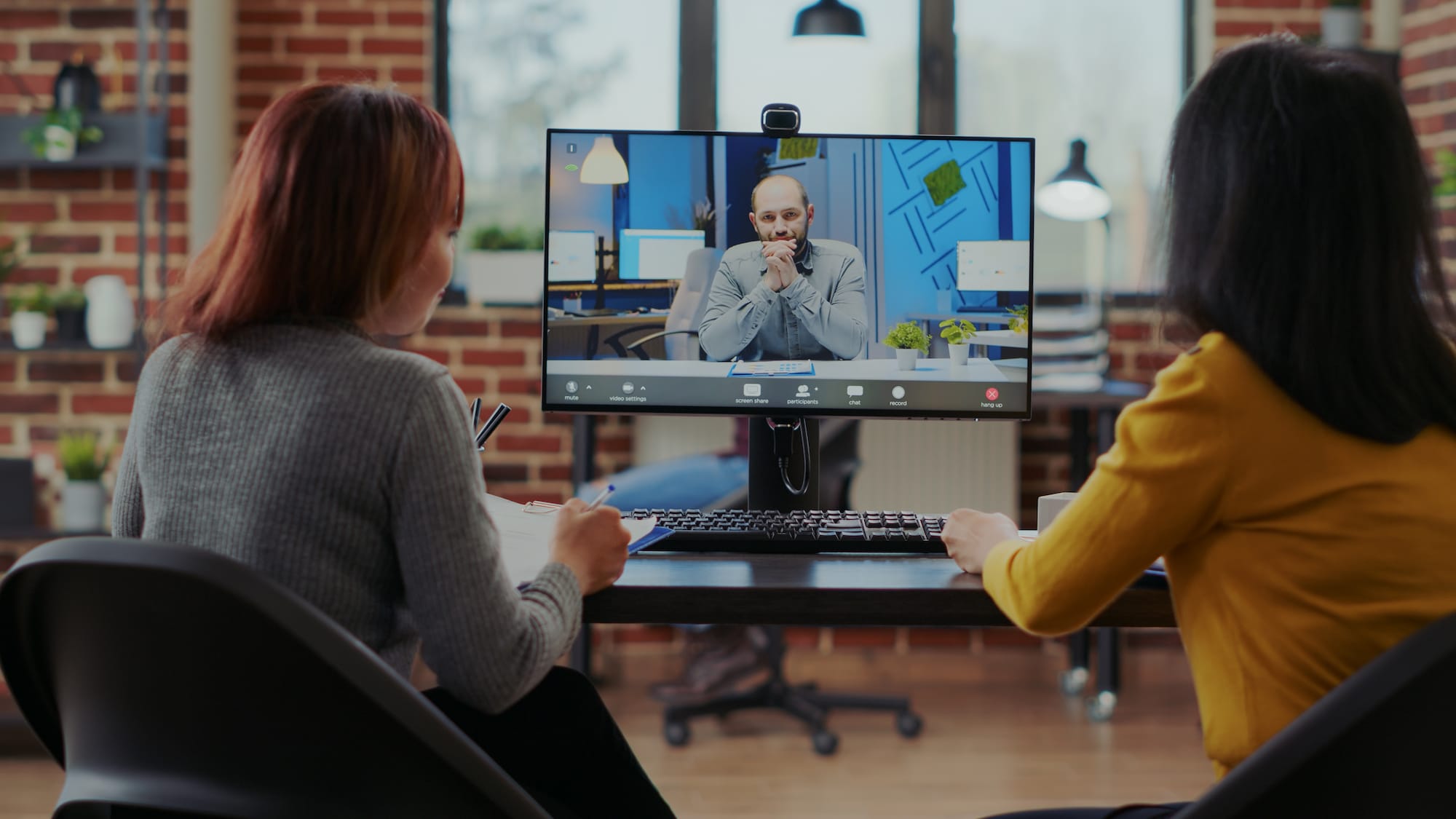 Team of people recruiting candidate on video call job interview in business office. Women talking to applicant about work employment and hiring, using remote videoconference on computer.